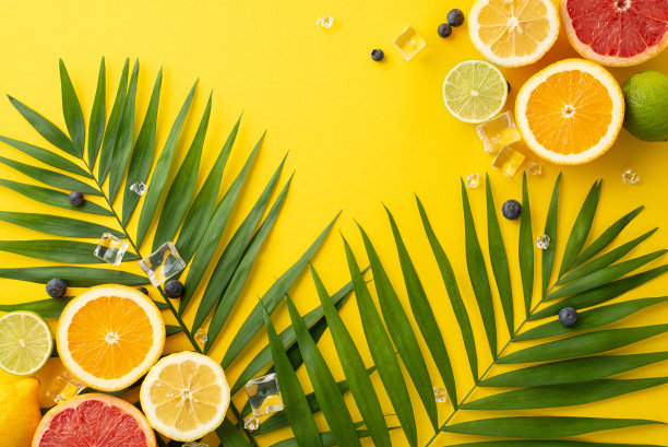捕捉夏天的精髓与这张俯视图照片柑橘类水果橙子葡萄柚柠檬酸橙和棕榈叶在黄色的背景图片下载