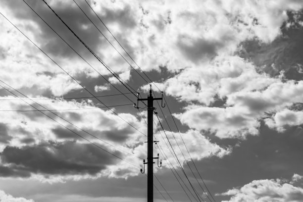 光背景上有电线的动力电线杆近景图片下载