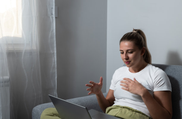 年轻快乐的女子拿着视频电话，向朋友、亲戚或父母打手势打招呼。迷人的女博主录制新视频给粉丝。微笑的女孩正在接受雇主的在线面试。图片下载