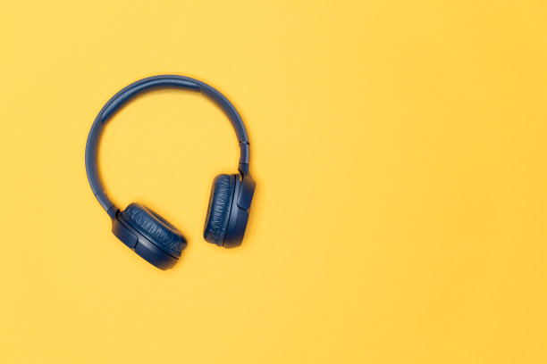 蓝色无线耳机，浅黄色背景。图片下载