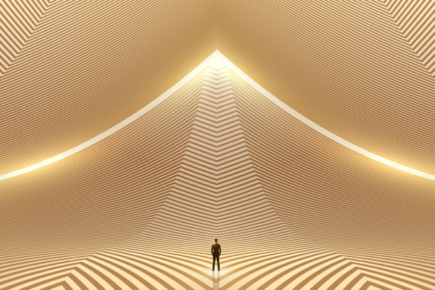 一位商人站在一幢金色线条建筑的过道上图片下载