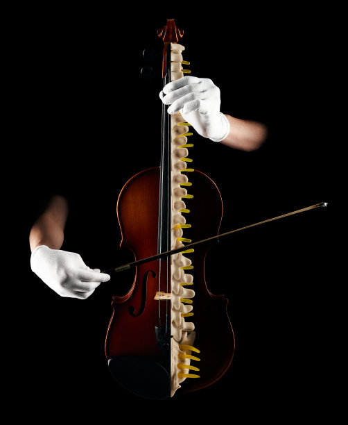 整骨，脊柱健康理念。手法治疗师专业治疗人体脊柱或脊椎骨，犹如演奏小提琴，艺术形象化图片下载
