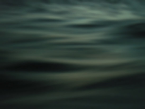 深黑色和绿松石色的海洋表面与波浪线图像纹理。图片下载