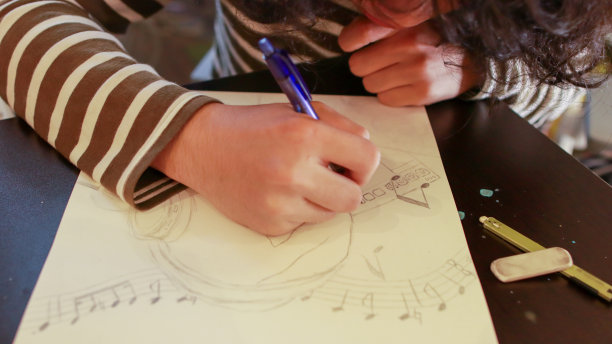 艺术学校的一名亚裔男生正在做设计作业图片下载