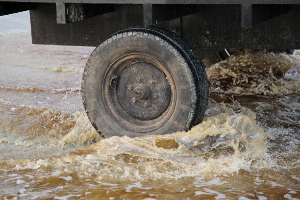 卡车车轮在潮湿的沙滩上溅起水花图片下载