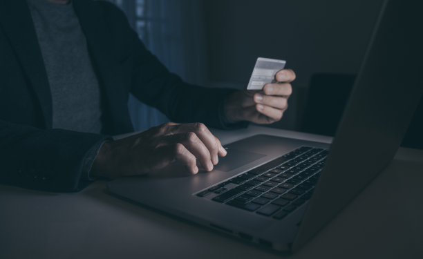 用信用卡在线支付购物。男人手里拿着信用卡购物和付款。新的银行图片下载