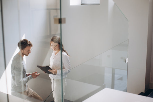男女企业家站在楼梯上讨论图片下载