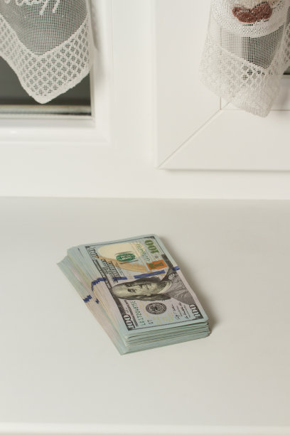 靠窗的一叠百元大钞，一份薪水。图片下载