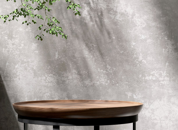 现代，简约的柚木圆形光滑纹理裙台，黑色钢腿，阳光下的绿色热带树，空白混凝土墙上的叶影图片下载