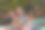 一对年轻夫妇在美丽的河流中央享受着田园诗般的皮划艇，周围是绿色的森林图片下载