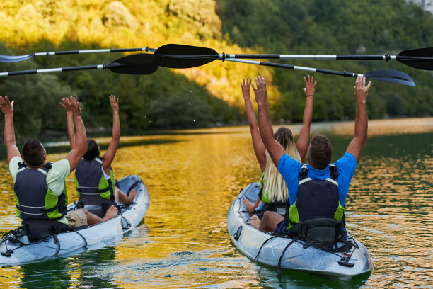 一群朋友在探索平静的河流，周围的森林和巨大的天然河谷时，享受着乐趣和皮划艇图片下载