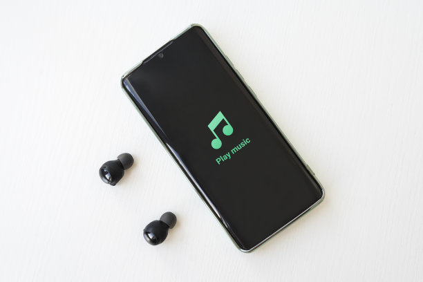 智能手机和耳机放在桌子上。专注于耳机。图片下载