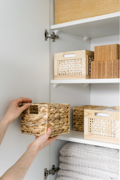 女人从家里的衣柜里拿出储物箱，特写图片下载