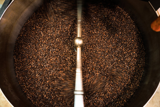 新鲜咖啡豆烘焙纺纱罩专业机近距离柔焦慢速快门速度因为想要使咖啡豆细节的运动模糊概念，在工厂泰国清莱，图片下载
