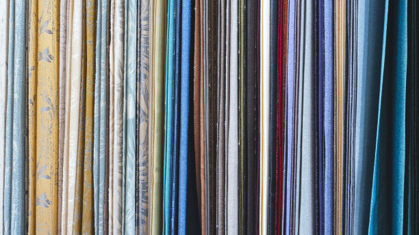 混色垂纹纺织品、面料、衣架上的布匹。近距离观察彩色织物的纹理。图片下载