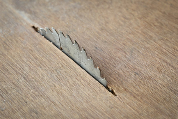 木板纹理背景上的锋利金属锯，施工机械图片下载