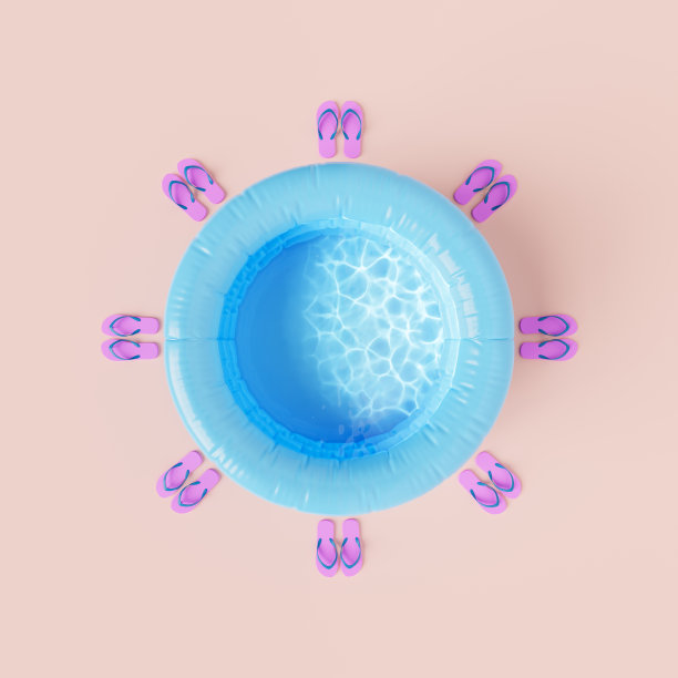 米色背景下的人字拖和充气泳池图片下载