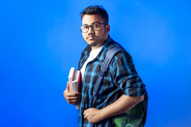 自信的大学生站在单色背景下图片下载