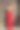 身穿优雅的东方红色连衣裙的年轻黑发女子站在有质感的中世纪墙壁前，西班牙，欧洲图片下载