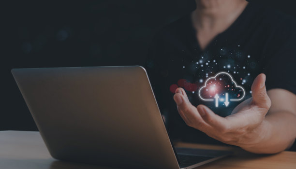 一个年轻人正在使用一台笔记本电脑，上面显示了一个云计算图。云计算。保存数据。网络和互联网服务的概念。图片下载