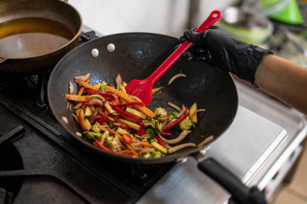 一家餐馆的拉丁女雇员正在厨房里为顾客准备美味的菜肴图片下载
