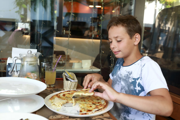 孩子拿了四个奶酪披萨图片下载