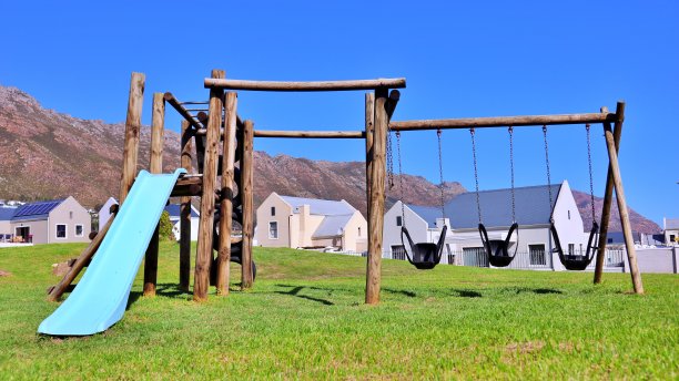 孩子们在公园里荡秋千和滑梯图片下载