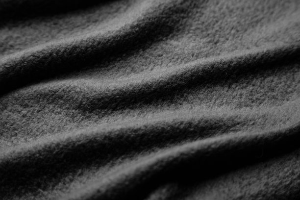有褶皱的保暖羊毛织物的质地。灰色波浪毡背景。图片下载