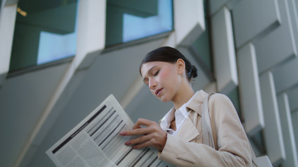 站在户外翻页的妇女近距离观看。商人读图片下载