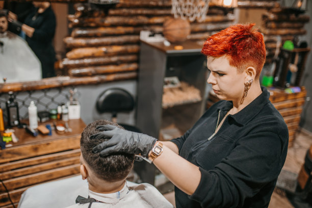 一位年轻的女理发师和一位年轻的顾客在理发店里图片下载