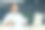 办公室工作。一个年轻的亚洲男人坐在桌子旁，用笔记本电脑和文件工作。他微笑着看着镜头图片下载