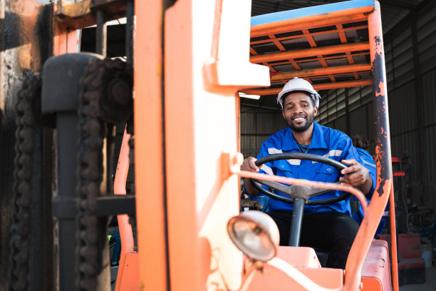 一个在仓库里用叉车工作的人的画像。概念工业和商业。图片下载