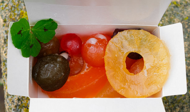 把水果放在包装盒里。露珠中的三叶草。图片下载