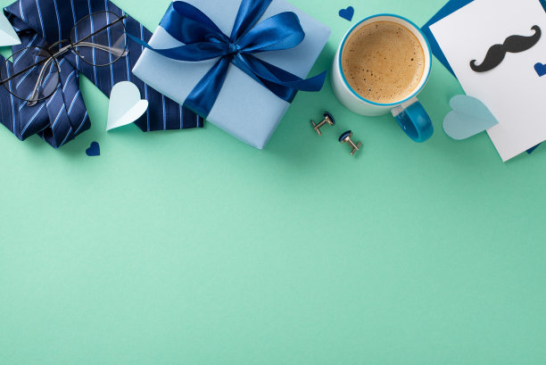 别致的父亲节安排。明信片，彩带礼盒，领带，袖扣，眼镜，纸心，咖啡杯在蓝绿色背景与文字的空间图片下载