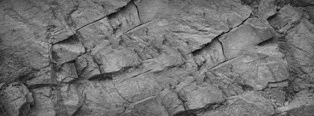 黑白色的。岩石纹理。山体表面开裂。特写镜头。3 d。灰色花岗岩玄武岩背景。宽横幅。图片下载