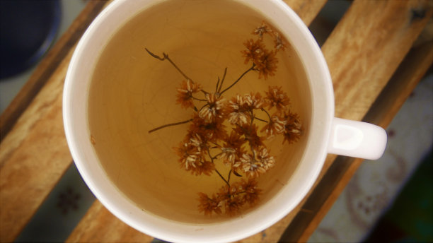 喝热茶。一大杯茶，特写镜头。桌子上有一个茶杯。木桌上的一杯茶。喝茶图片下载