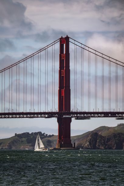 一个风景如画的下午，帆船驶过旧金山湾的金门大桥图片下载