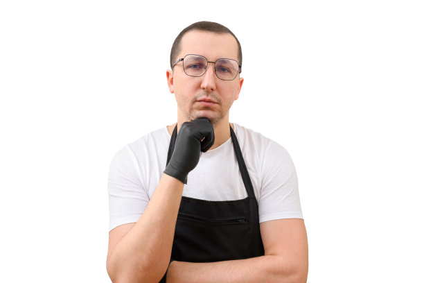 白色背景上，一个男人系着围裙，戴着手套。烹饪的概念图片下载