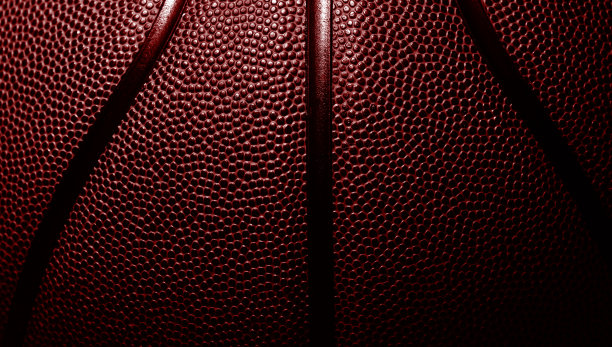 红色篮球纹理背景的特写细节。横向运动主题海报，贺卡，标题，网站和应用程序图片下载