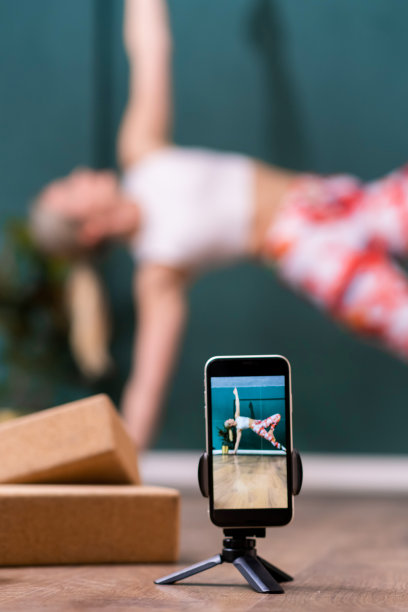 在线瑜伽课在演播室女教练做运动录像图片下载