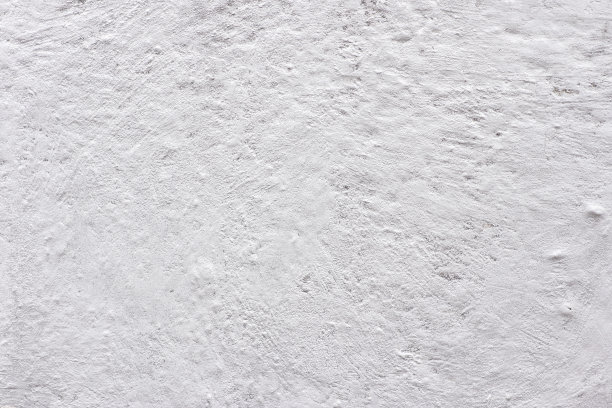 这油漆的质地是白色的。墙面背景有灰泥和污渍。一个屏幕保护程序或一张度假明信片。图片下载