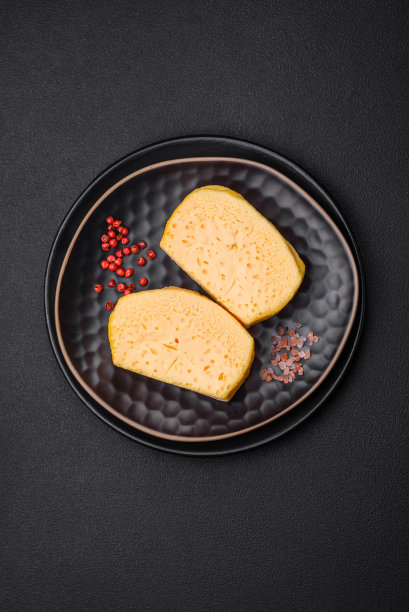 美味多孔黄色奶酪切成大块放在陶瓷盘子上图片下载