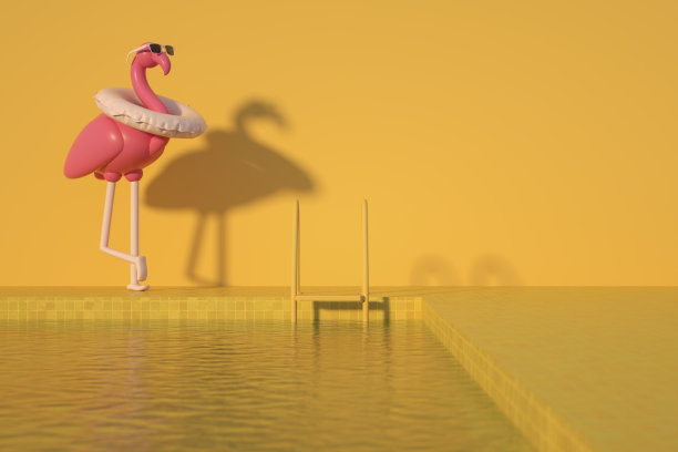 充气火烈鸟和游泳池，黄色背景的暑假旅游概念图片下载