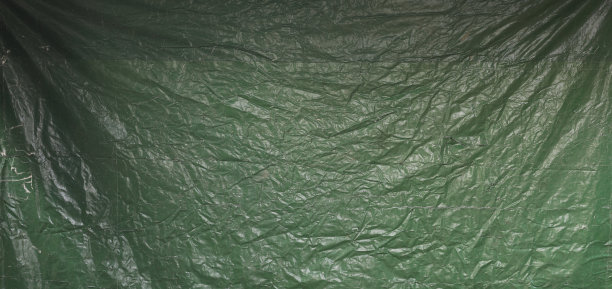 绿色抽象的皱巴巴的旧篷布背景图片下载