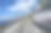 一辆白色的公共汽车沿着高速公路行驶，背景是美丽的风景。图片下载