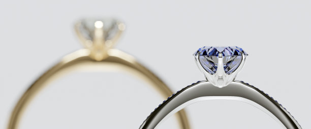 蓝色钻石白金戒指微距聚焦与金戒指，模糊的背景。用3D渲染设计概念中的订婚戒指和结婚戒指。图片下载