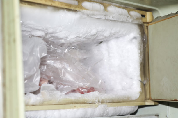 冰箱的空冰柜里装满了冰，使冰箱工作更辛苦图片下载