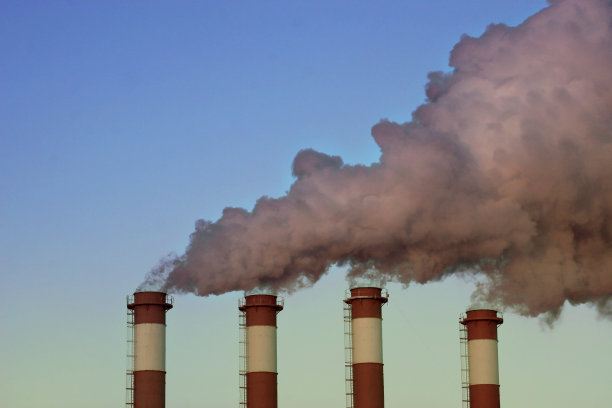 工业烟囱冒着白烟，映衬着蓝天。图片下载