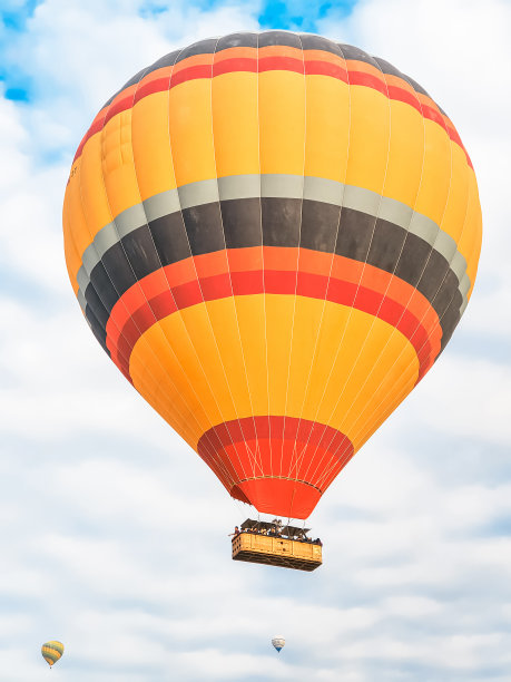 天空中飞着许多色彩鲜艳的美丽的气球，在卡帕多西亚的山上，日出、黎明时分飞向空中。用燃烧器，大篮子里的热空气填充气球。游客游览，云游飞翔图片下载
