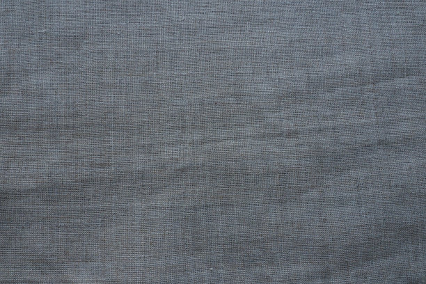 织物纹理背景。有组织的灰色织物。材料的自然微皱外观。统一的拷贝空间背景。棉、帆布或羊毛薄织物均匀地铺在表面。图片下载